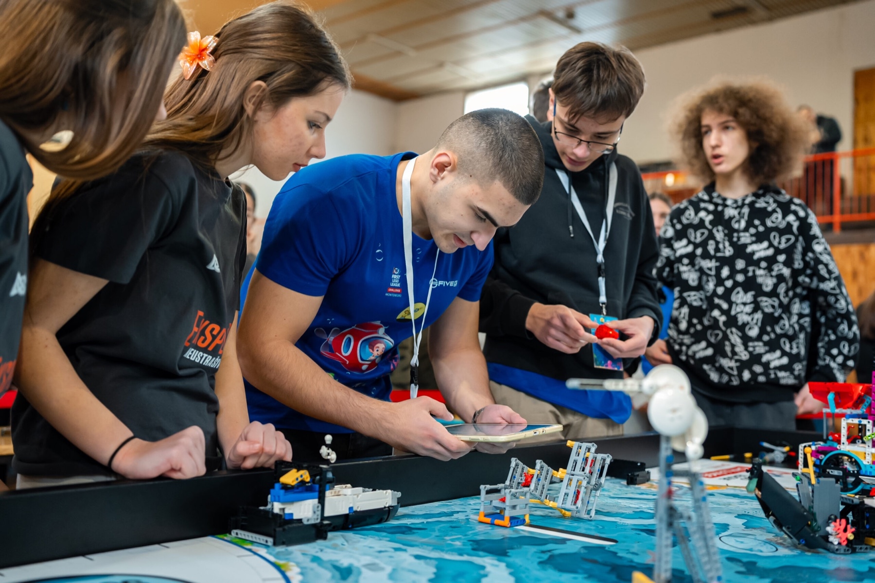 A team at the robot game table preparing the robot for its next mission