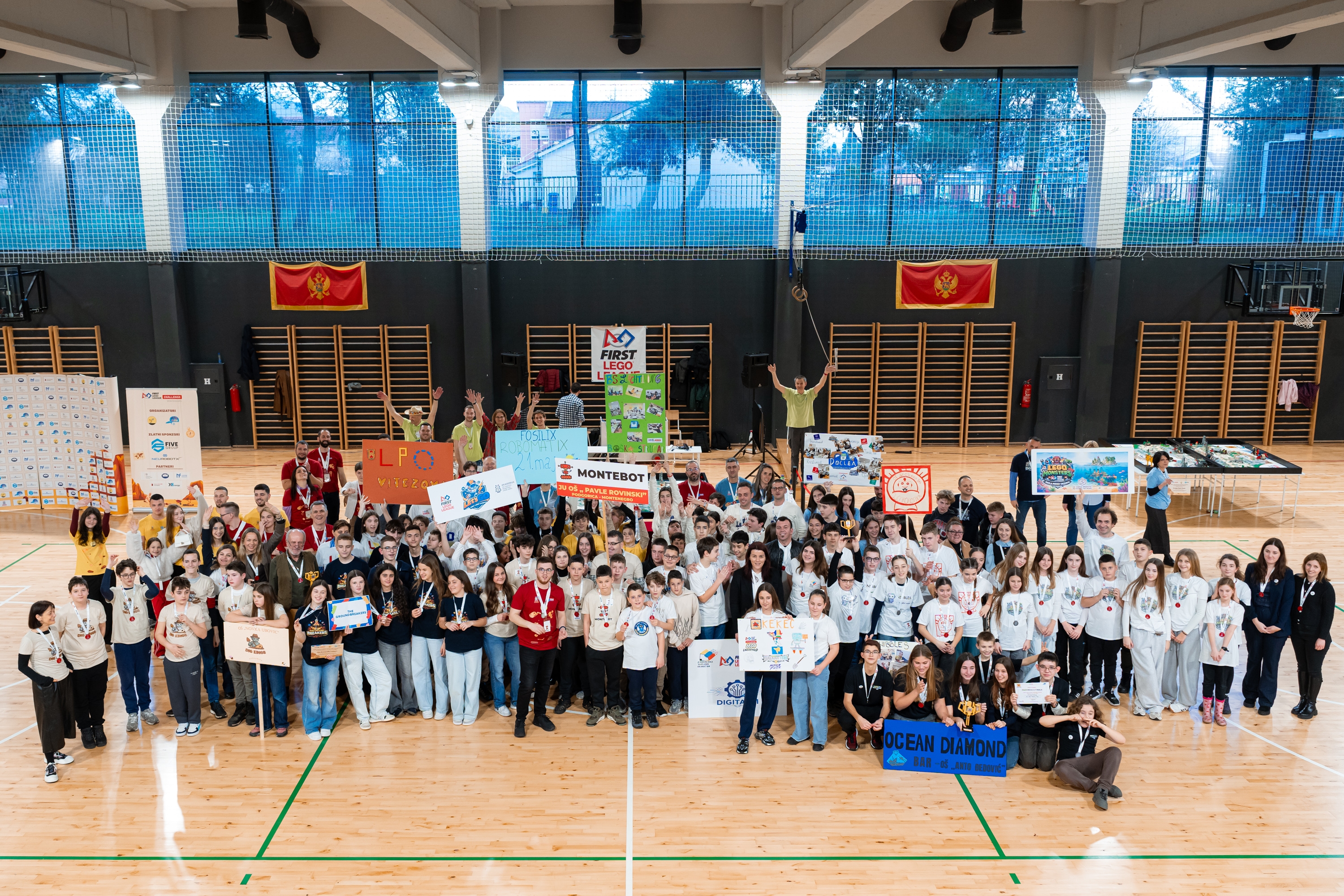 Teams and participants of a FIRST LEGO League competition gathered in a sports hall