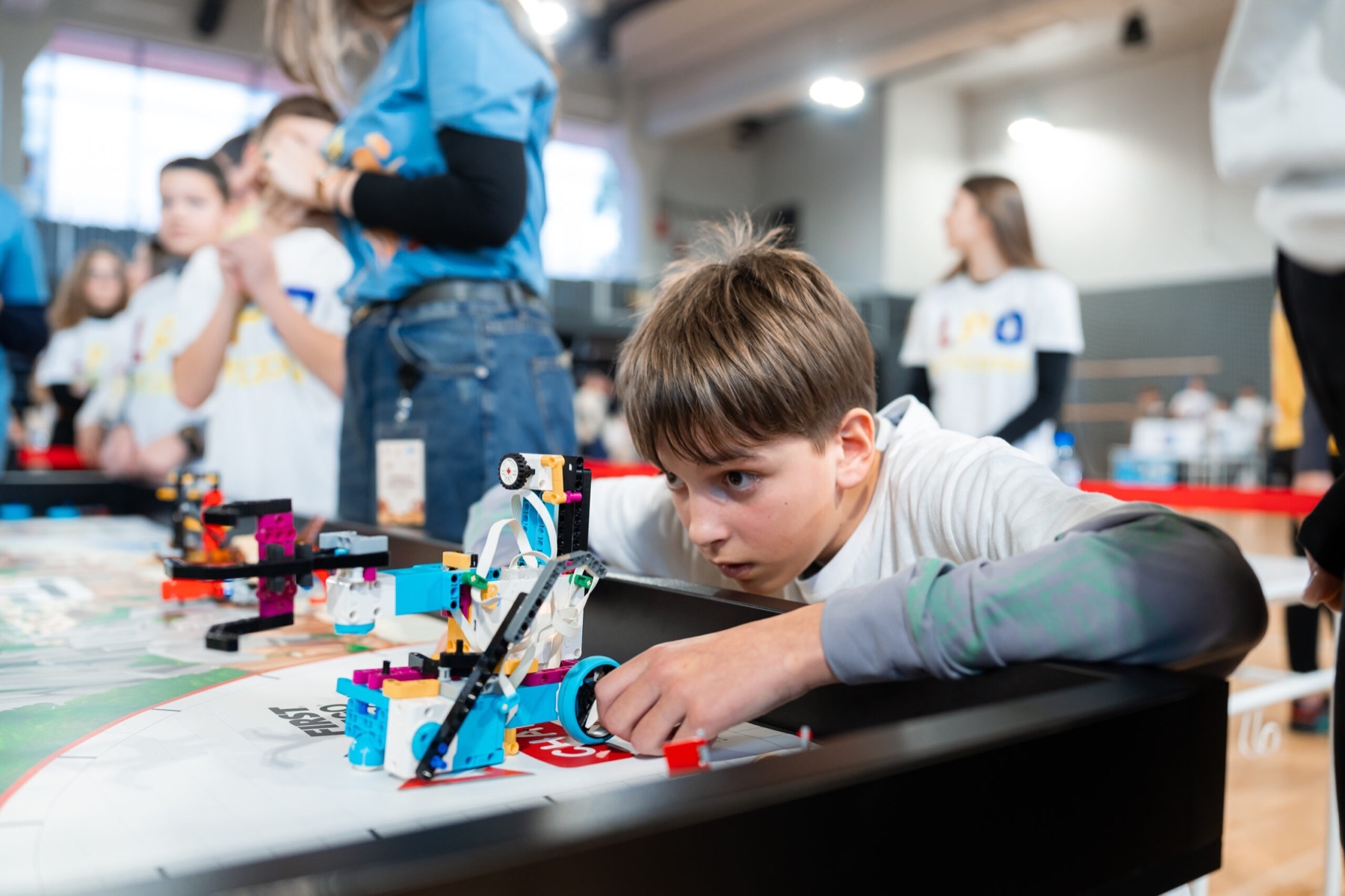 A competitor carefully positions the robot at the start of the robot game