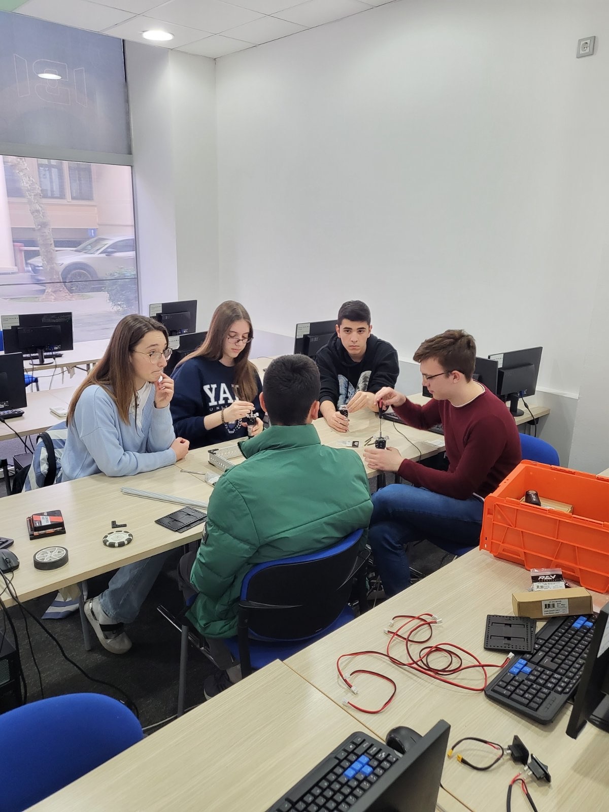 High school students assembling robots at the “Introduction to Robotics” workshop